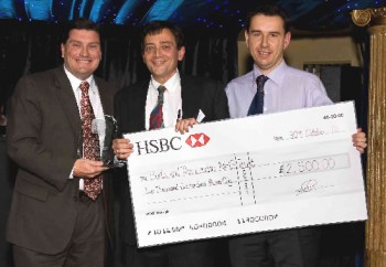 Mr. Paul Marcum, Managing Director of Ethicon Endo-Surgery, Johnson & Johnson Medical Ltd. (left), presenting the NHS Innovator Award to Professor Theodosios Alexander (centre) and team member Dr. Thomas Keeble (right).