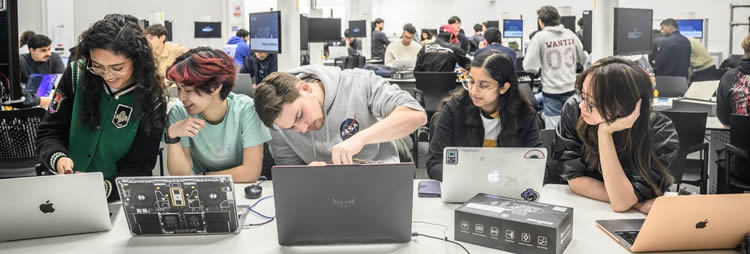 Robotics students working in a large classroom