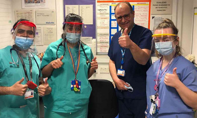 Staff at Royal London Dental Hospital wearing visors prepared by the team.
