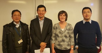 Pihua Wen (left), Steffi Krause (2nd right),  & Guang Li (right) being congratulated by the Wen Wang.