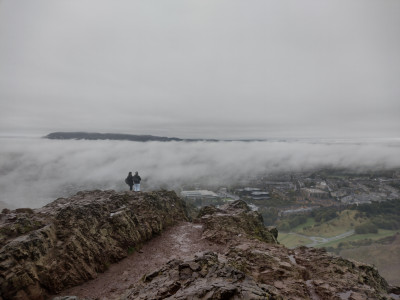 The top of Arthur's Seat looking towards the Pentland Hills rising above the cloud.