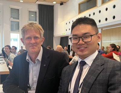 Huan Meng with PhD supervisor Prof Martin Knight at a research conference in Switzerland.