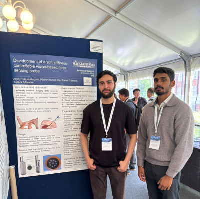 Arvin (right) and Hashir (left) standing close to their poster