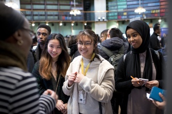 Students talking to an alumni visitor about career options after QMUL