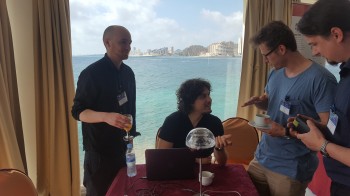 Hugh (left) and Michele (2nd left) are busy explaining their prototype device to conference delegates.