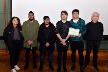 The MEng group being congratulated by Dr Adrian Briggs (on the right)