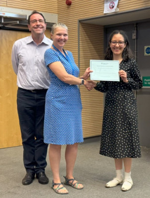 Hazel (middle) congratulating Maria (right). Proud supervisor photo bombing behind.