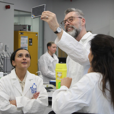 click/tap to enlarge this image... Representatives from Lush holding a piece of the technology up to look at it.