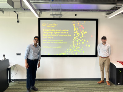 click/tap to enlarge this image... Dr Shah and his student presenting their research
