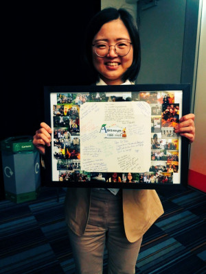 Qian with a present with pictures of her time at QMUL during her PhD put together by the group.