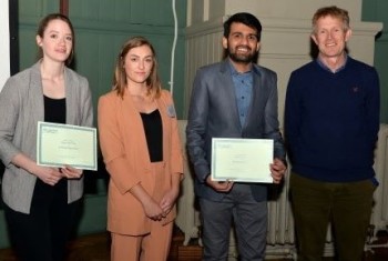 Megan (left) and Hudair (2nd from right) collecting their poster prizes