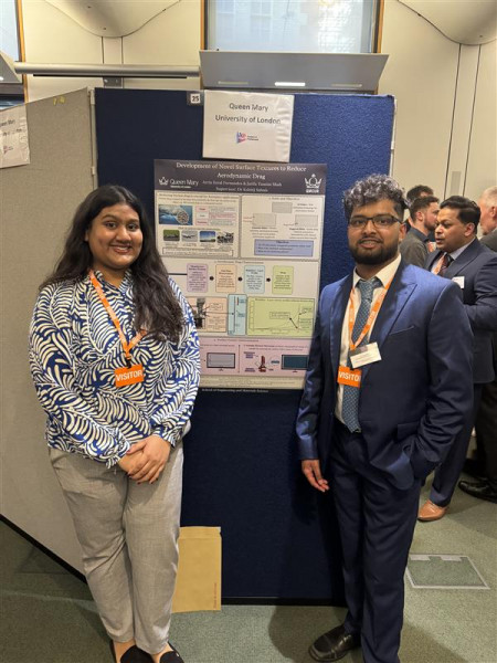 Jarifa with her poster on a blue board at Posters in Parliament