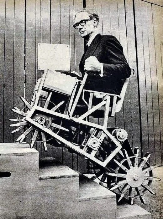 Prof Meredith Thring demonstrating his stair climbing chair