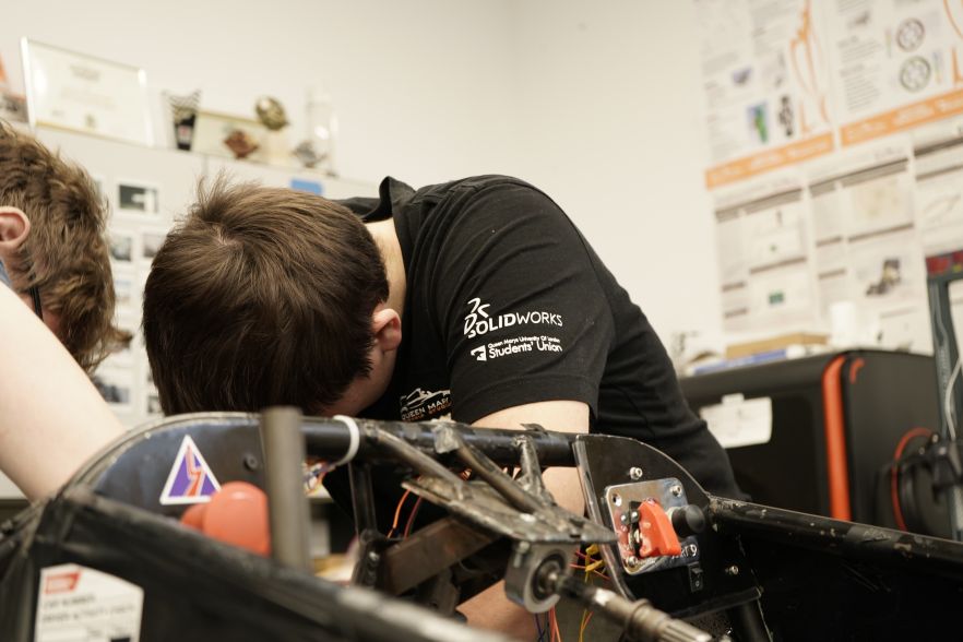 A student works on a formula one vehicle